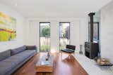 A wood-burning stove is accented by a custom cast-concrete surround in the living room.