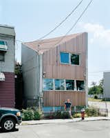 Carpenter poses outside his house, which is shoehorned into a tiny nonconforming lot among a block’s worth of older row houses and a derelict public park.  Photo 6 of 7 in All in the Family: 7 Spaces Designed by Couples by William Lamb from Garden Statement