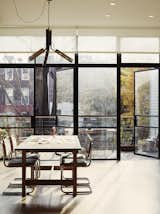 Dining Room, Pendant Lighting, Chair, and Table The decidedly modern dining and kitchen areas open to the backyard through a floor-to-ceiling steel-and-glass door, fabricated by Optimum Window. One of the owners’ favorite features of the home is the “ability to connect the inside to the outside seamlessly,” Bangia describes. The living area serves as “a place for the kids to dance or ride a skateboard, a casual space that reflects the way they live.”  Photo 1 of 8 in Rincón de trabajo by Ignacia Romero from It's Back to Basics for This 1901 Brooklyn Town House