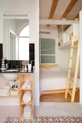 This shared micro-living space designed by Miel Arquitectos and Studio P10 in Barcelona, Spain, houses two units in a single 700-square-foot structure. Each apartment comprises separate sleeping and bathing quarters, with a shared central kitchen and dining area.  Photo 2 of 7 in small space by AYESHA ASGAR from Small City Homes, All Under 1,300 Square Feet