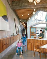 Kitchen, Wood Cabinet, Concrete Floor, and Pendant Lighting Omer Arbel, the creative director at industrial design firm Bocci, was given three parameters when he began designing a home for his colleague Randy Bishop: Create a “profound” connection between the internal and external spaces; build only one level; and, most crucially, utilize a wealth of 100-year-old beams salvaged from a series of warehouses owned by Bishop’s ancestors.  Search “mountaintop modern” from Material Focus: Custom Walnut Designs 