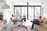 Brothers Nima and Soheil relax in the family room on an Eames lounge chair and a custom sofa they designed. “Mid-century architecture draws the outdoor environment indoors,” says Soheil. “There’s a lot of natural light, a lot of ventilation.”