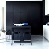 A wall of sleek black cabinets defines this kitchen project.