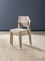 The chairs are stackable with a webbed seat. They come in white, blonde, light gray, and black.