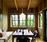Inside, the dining nook is similarly clad in Western cedar, augmenting the home's connection to the outdoors.  Photo 2 of 9 in 5 Main Ingredients For Cooking Up a Homey Kitchen Nook from A New Home Tries to Camouflage Into the California Coast