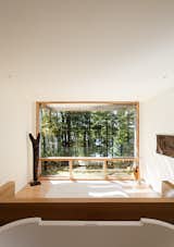 Operable windows on the South- and North-facing facades allow cross ventilation The bedroom is spartan, save for an impressive view of the trees.  Photo 1 of 15 in Bedroom by Patrick Mack from Peek Through the Trees and Spot a Modern Dream Home