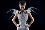 Fashion-tech designer Anouk Wipprecht’s white Spider Dress 2.0 was developed with Philip Wilck along the lines of a previous dress she made inspired by arachnids. The 3D-printed robotic garment with eight jointed arms (activated by sensors and Intel Edison chips with artificial bio-signal intelligence) protects the wearer. Depending on the wearer's mood—agitated or pleased—the arms of the dress spring upward to ward off intrusions.