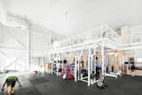 Microclimat split the interior into two levels, leaving space open to accommodate many kinds of regimens and athletes, from gymnasts to body-builders. A mezzanine with fitness machines is lofted above a weight-lifting area.