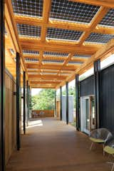 Outdoor and Wood Patio, Porch, Deck Porches are a beloved element of the Southern vernacular and lifestyle, traditionally serving as an extension of the indoors—a shady place to gather, socialize, or share a meal. So when the students of Appalachian State University in Boone, North Carolina, entered the Solar Decathlon, a biennial energy-efficient residential design competition, the iconic space figured prominently in their concept. Here, a canopy of bifacial solar panels covers the porch and provides energy for the home.  Search “solar” from About Face