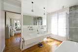 "The old living room and balcony on the sixth floor were transformed into the master bedroom with an en-suite open bathroom," Hammer said. Flos lighting illuminates the space above the vanity.