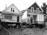 The original structures were lifted from their foundations to accommodate new ground-floor units.  Photo 2 of 7 in As Housing Costs Soar, Two Homes Multiply to Seven