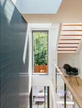 Staircase and Wood Tread The laneway house features Kentwood engineered-wood floors, Cascadia windows, and aluminum-bar grating. The Eames DAX chair is vintage.  Photos from As Housing Costs Soar, Two Homes Multiply to Seven