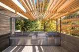 At one end of the L-shaped terrace, interior designer Martine Brisson included room for a full outdoor kitchen so the family could prepare meals without stepping inside during the warmer months.