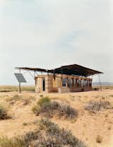 Exterior, House Building Type, Stone Siding Material, and Wood Siding Material Entirely off the grid, the house is powered by four photovoltaic panels that supply electricity to lights, small appliances, and water pumps.  Photo 1 of 8 in No Grid in Sight
