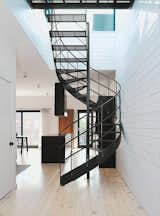 Staircase, Metal Tread, and Metal Railing Di Ioia and Bédard designed the wrought-iron spiral staircase that leads to the rooftop terrace and sauna as a visual nod to Montreal’s signature outdoor stairways.  Photo 5 of 8 in STAIRCASE by Brogan Laine Bradfield from Scandinavian Style Revives This Montreal Home