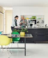 The couple have crafted their own kitchens in the past. For their floating home, however, they selected the black Vipp kitchen, where Juul chats with her daughter, Karla.