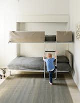 The bunk bed, the Lollipop IN model from Resource Furniture, stows away flush to the wall when not in use.