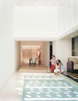 The dining area feels like an extension of the pool, with water channels on two sides.