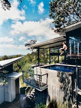Outdoor, Plunge, Swimming, Small, Concrete, and Small Dunlop demonstrates the deck’s secondary use: as a launching pad into the concrete plunge pool on the first floor.  Outdoor Swimming Small Concrete Photos from Hillside Family Home in Australia