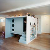 Danish furniture and product designer Nina Tolstrup, who works under the name Studiomama, conceived a huge, freestanding medium-density fiberboard (MDF) cube punctured with circular windows that acts as her children’s playroom inside her London home.
