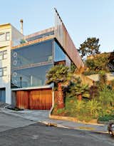 Mechanical engineer Jan Moolsintong and industrial designer Peter Russell-Clarke enjoy epic views of San Francisco from their 1,800-square-foot house overlooking the Mission District. The distinctive facade has operable porthole windows and a slatted garage door that was custom-built by Raimundo Ferreira.