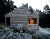 When Oslo-based architect Marianne Borge was approached in 2004 by a client who wanted an actual cabin rather than a second home, she was instantly inspired by the challenge of working on a smaller scale. The home, called Woody35, has a distinct shape that makes it stand out from its surroundings despite the modest size of the building.