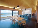 Dominic Houser's no-nonsense longhouse in the Hebrides of Scotland—an archipelago on the northwest coast—features a blue that mirrors the color of the ocean. The vaulted space and uncluttered interiors are perfect for Houser's regular meditation practice.