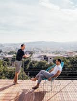 Outdoor, Wood Patio, Porch, Deck, and Large Patio, Porch, Deck The roof deck has a commanding view. “We have friends out here in the summer and stay too long drinking wine,” says Bradley.  Search “San Franciscos Forgotten Modernism” from A Home with Eclectic Style Looks Just Right