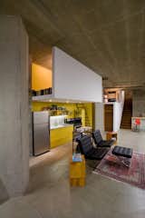 "The kitchen didn’t really have a home," says Colkitt. His solution was to build a sleeping loft directly above it, giving the kitchen some architectural congruity, and implement recessed lighting into the dropped ceiling—also the underside of the floor of the sleeping loft. Like the reading loft, the sleeping loft is open on both sides to bring in light and air, with a single ladder leading up to it. "The sleeping loft ‘fold’ is a complement to the reading loft ‘fold’—they balance each other out," says Colkitt.&nbsp;