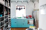 The budget was nearly as tight as the space in this cheerful renovation of a 516-square-foot flat in Bratislava. The centerpiece of Lukáš Kordík’s new kitchen is the cabinetry surrounding the sink, a feat he managed by altering the facing and pulls of an off-the-rack Ikea system. The laminate offers a good punch of blue, and in modernist fashion, Kordík forwent door handles in favor of cutouts. “I wanted the kitchen to be one simple block of color without any additional design,” he says.