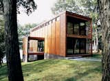 Milwaukee studio Vetter Denk Architects designed this eye-catching prefab on the banks of Moose Lake, Wisconsin, as a weekend retreat. 

The home was based on an idea presented by the home's owner, who was inspired by a screw-top jug of $9.99 red wine.