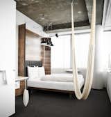 There are no closets and no minibars in the guest rooms, reflecting the designers' minimalist approach. Features include a curved wooden headboard and a hammock hanging from the ceiling. Unfinished ceilings reveal partitions of the old structure, even down to the screws.