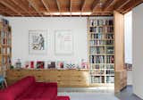 Wood, Interior, Swing Door Type, Living Room, and Sofa The door to Eoghan Mahony’s office is set on a caster and has a hinge that runs the entire ten-foot height.  Search “modern-family” from The Garage That’s as Fun as the Living Room