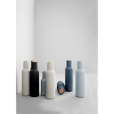 Cast in similar colors to the Norm Dinnerware collection, these Bottle Grinders are shaped like small bottles, giving them a distinctive look that sets them apart from more traditional shaker sets.