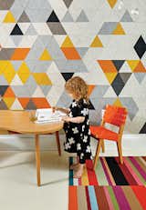 Chris Grimley and Kelly Smith transformed a cramped apartment into a family-friendly home. The room shared by Mae, three, and her little brother Roen, one, features a custom prototype mural by FilzFelt, their mother’s textile design company. The carpet is by Flor, and the child-size chair and Amoeba table are both by Jens Risom for Knoll.