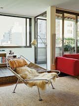 A Flag Halyard chair by Hans Wegner in long-haired sheepskin occupies one end of the living room.