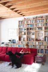 Wes Mahony lounges on a Tufty-Time sofa by Patricia Urquiola for B&B Italia in the family room that architect Emily Jagoda created for his family in their tree-damaged garage in Santa Monica.