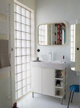 Bath Room and Drop In Sink The Basics series radiator by Italian manufacturer Tubes doubles as a towel rack in the bathroom. Deau purchased the cabinet and mirror from Ikea and she found the stool at a flea market.  Search “lana-towel.html” from Modern Home Furnished With Flea Market Finds