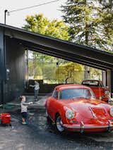 Lilyvilla Gardens built custom wood and concrete steps connecting the street to the house, which flow into an exposed patio under the refurbished carport. In addition to collecting midcentury furniture, Ty Milford is a vintage car aficionado and owner of two cherry red Porsches.
