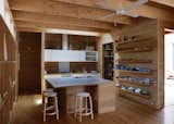 Kitchen and Medium Hardwood Floor The almost-entirely tallowwood kitchen is custom. Muuto pendant lights, bar stools by Alvar Aalto for Artek, a Vola faucet, and a ceiling fan by Beacon Lighting finish the room.  Search “officefloors--medium-hardwood” from Local Wood Clads Every Surface of This Idyllic Australian Getaway