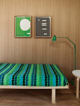 Bedroom, Bed, Medium Hardwood Floor, Night Stands, and Floor Lighting Räsymatto bedding by Marimekko in the studio is complemented by a green Anglepoise lamp from Sydney boutique Planet Furniture.  Photo 19 of 20 in The Best Places to Buy Hotel-Quality Bedding That Won’t Break the Bank from Local Wood Clads Every Surface of This Idyllic Australian Getaway