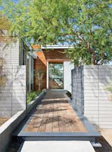 Exterior, House Building Type, and Wood Siding Material An ipe walkway leads past a steel gate to the guesthouse.  Photo 2 of 12 in Vacation Home in the California Desert is a Modernist Oasis