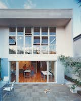 Outdoor and Decking Patio, Porch, Deck Clayden is perfectly happy enjoying the subtropical sun on the balcony, though his much-beloved cat Ginger appears far more enthusiastic about lolling on the patio.  Photo 10 of 10 in Modern Rear Facades by Jami Smith from Minimalist Bachelor Pad in Brisbane