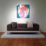 One of the pieces Sottsass designed for Poltronova in 1965 is the beech wood Califfo settee, which Pivano and Sottsass had in their apartment in a gray upholstery. The portrait of Marilyn Monroe was given to Sottsass by Andy Warhol and Warhol associate Gerard Malanga. According to Christie's specialist Simon Andrews, David Bowie was gifted with an identical colorway of the Marilyn print.