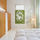 The bedroom is decorated minimally by another Vogt screenprint, and a strand of green Algue.