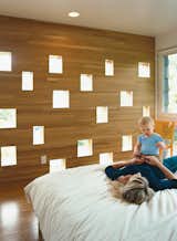 Karie and Mason enjoy a playful loll on the bed in the Deans’ new master bedroom. The perforated wall facing the neighbors’ backyard offers a great deal of diffuse light while still managing to conceal the Deans’ boudoir from prying eyes.