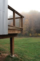 An off-the-shelf post-and-beam system is used as foundation for the porches.  Welded wire mesh is used for the guardrail. Image courtesy Chad Everhart Architect.