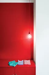 Now that the interior’s palette is firmly in place, Winterhalder has slowly been adding splashes of color. E27 pendant lamps from Muuto in the kitchen and guest room have red cords; one wall in the guest room is also red, with matching red locker storage. The inside of the front door is painted bright green. "For me, they’re kids’ colors," she says. "I just love them."