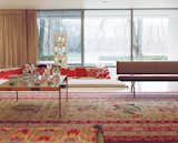 In the main living room, the pillows in the sunken seating area changed colors with the seasons: reds for the winter and lighter pastels for the warmer months.  Photo 8 of 10 in Great Rugs to Tie the Room Together by Jami Smith from Modern Multihued Interiors