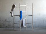 Another minimalist clothing rack by Jakob Jørgensen, a frequent collaborator with Line Depping, comprises a simple wedge assembly that attaches a horizontal element to a vertical load-bearing element.